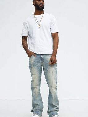 12. Nova Men • NWT $65 Ripped and Bleach splatted stacked Slim Flare Jean